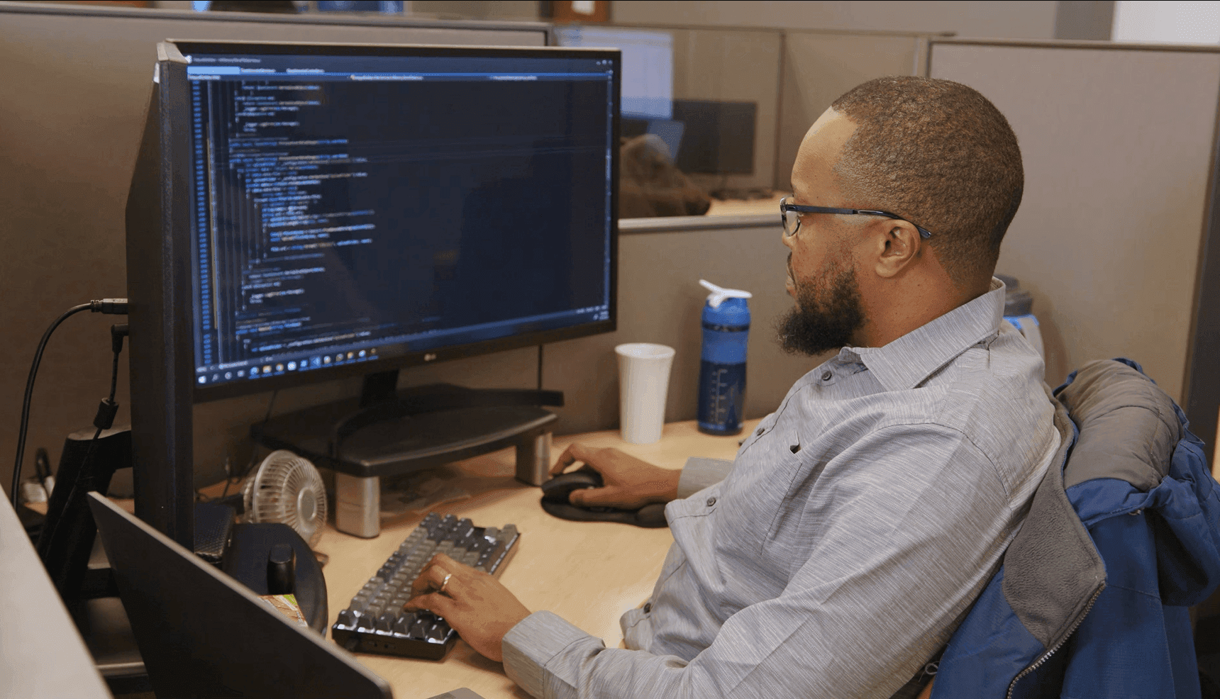 Developer at desk with monitors